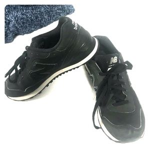 matte black New Balance sneakers